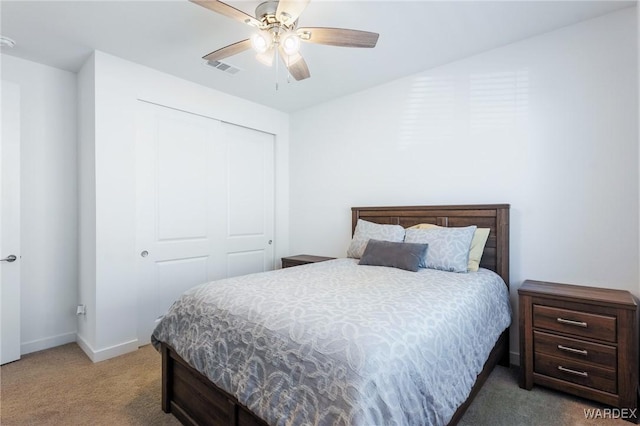 bedroom featuring ceiling fan, carpet flooring, visible vents, baseboards, and a closet