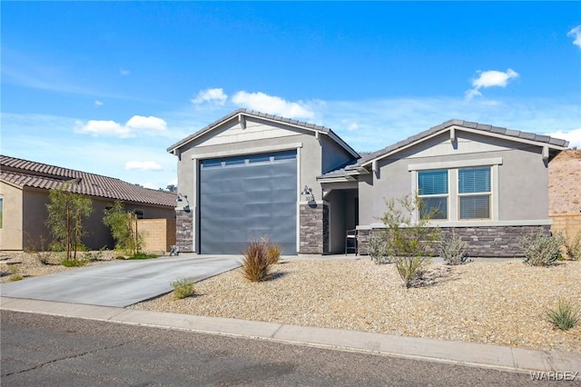 view of front of home featuring an attached garage, stone siding, concrete driveway, and stucco siding