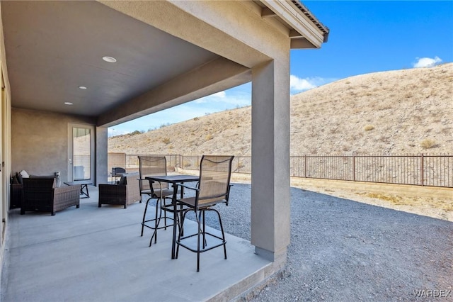 view of patio with fence private yard and a mountain view