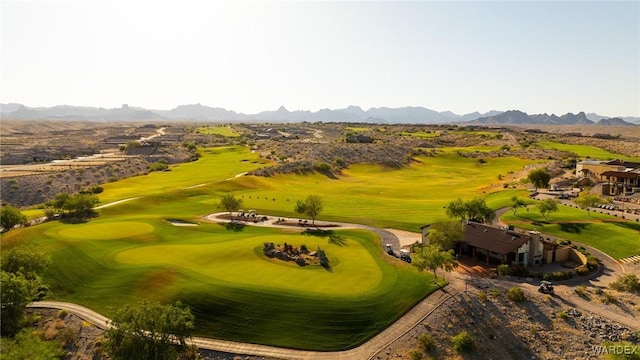 birds eye view of property with view of golf course and a mountain view