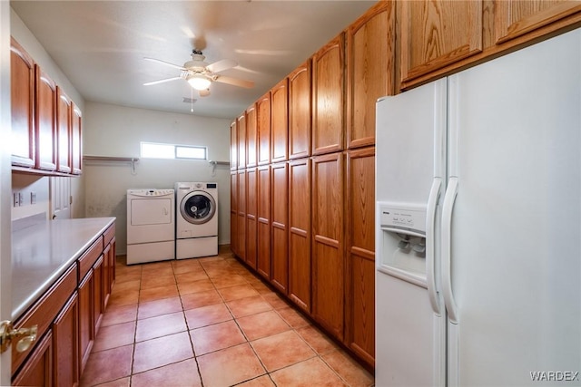 washroom featuring ceiling fan, light tile patterned flooring, washing machine and clothes dryer, and cabinet space