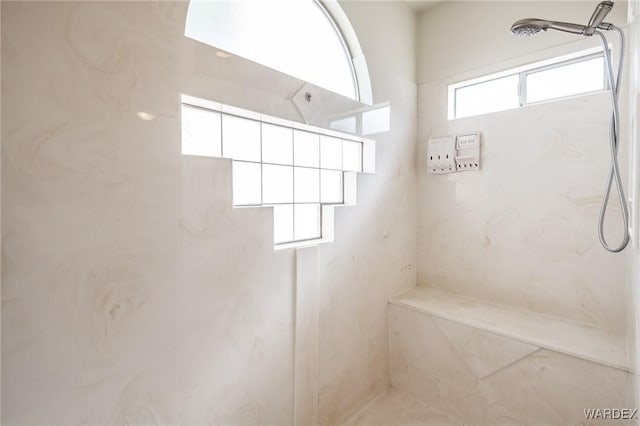 full bath with a marble finish shower