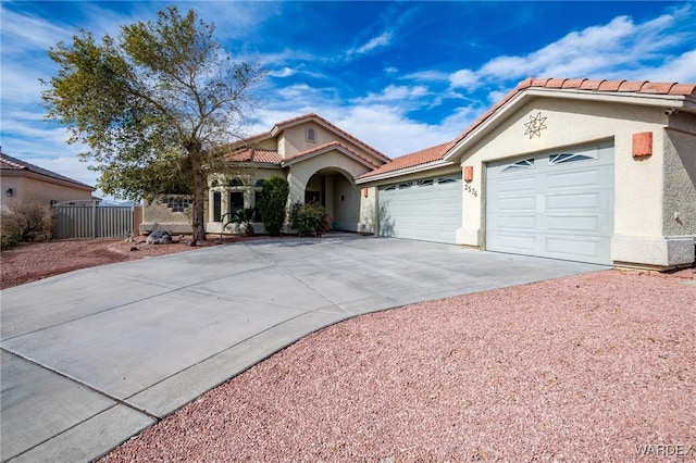 view of front of home featuring a garage, driveway, a tile roof, and stucco siding