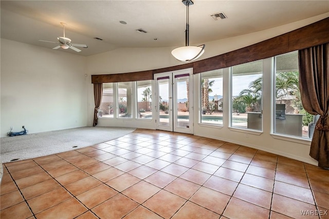 spare room with lofted ceiling, light tile patterned floors, ceiling fan, and visible vents