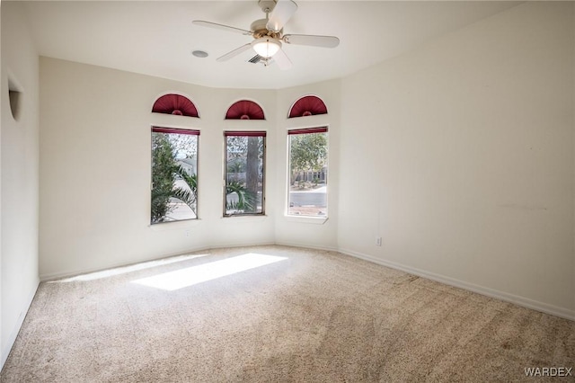 unfurnished room featuring carpet flooring, a ceiling fan, and baseboards