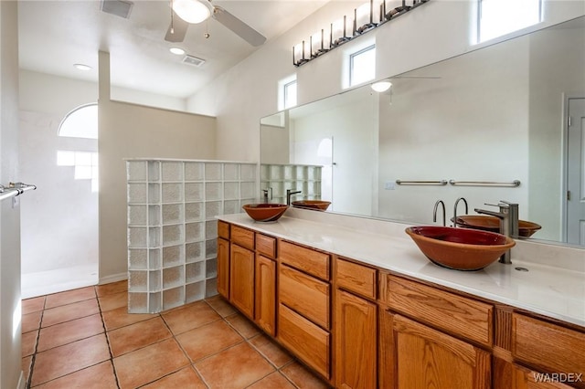 bathroom featuring ceiling fan, double vanity, tile patterned flooring, and a sink