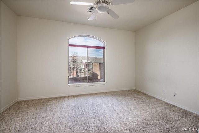 carpeted empty room with ceiling fan, visible vents, and baseboards