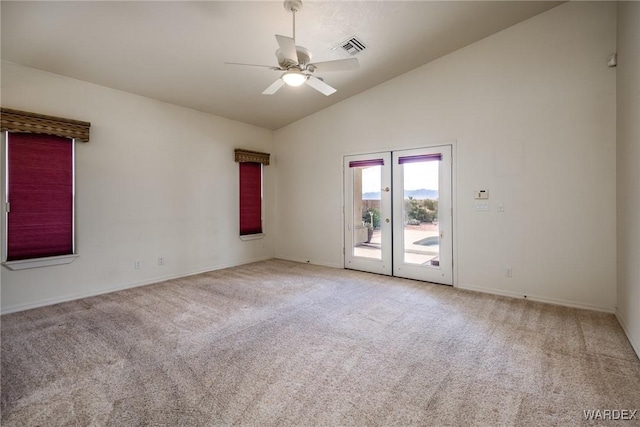 spare room with high vaulted ceiling, carpet floors, visible vents, baseboards, and a ceiling fan