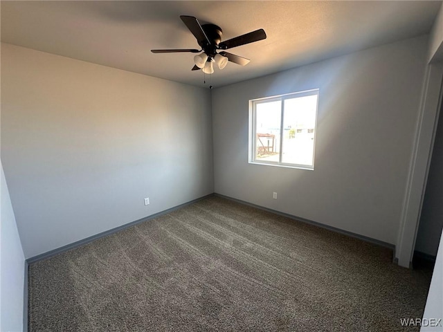 carpeted empty room with baseboards and ceiling fan