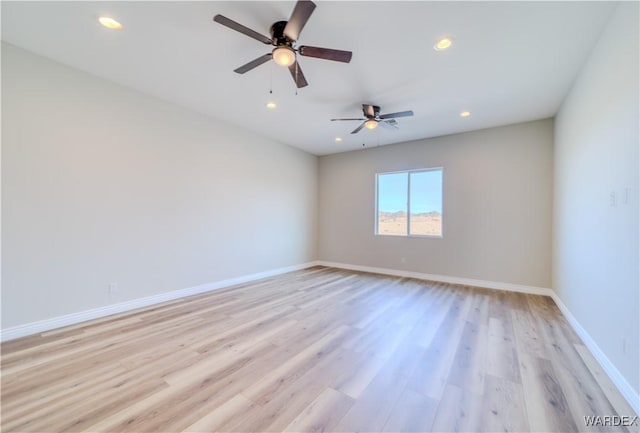 spare room with light wood-type flooring, baseboards, and recessed lighting