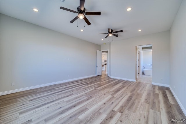 unfurnished room featuring light wood-style flooring, baseboards, and recessed lighting