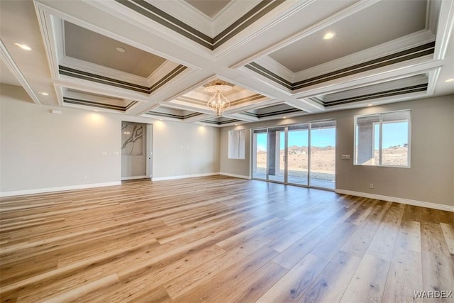 spare room featuring light wood-style floors, coffered ceiling, crown molding, and baseboards