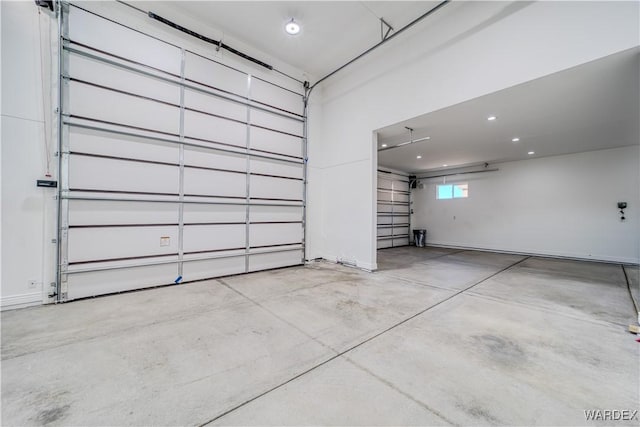 garage featuring recessed lighting and baseboards