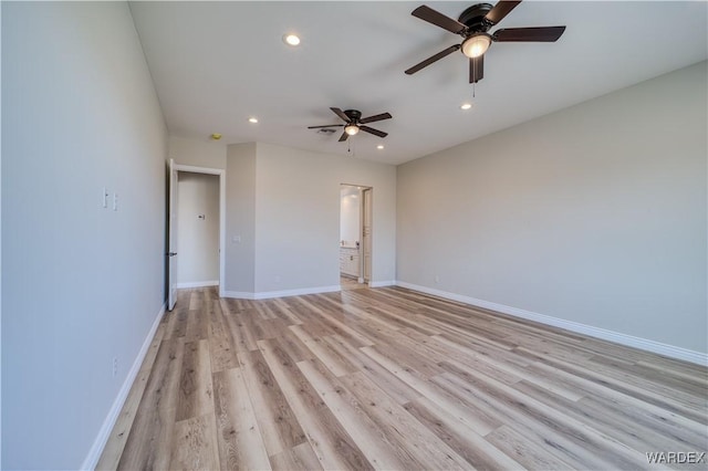 unfurnished room featuring recessed lighting, light wood-style flooring, and baseboards