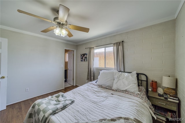 bedroom featuring crown molding, ceiling fan, and wood finished floors