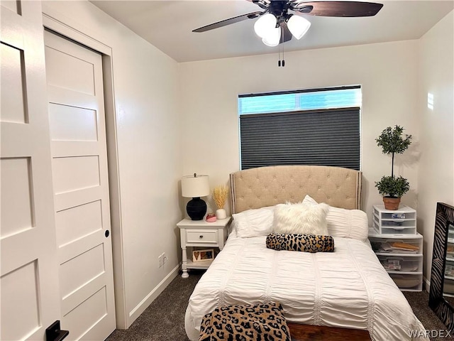 bedroom with baseboards, dark carpet, and ceiling fan