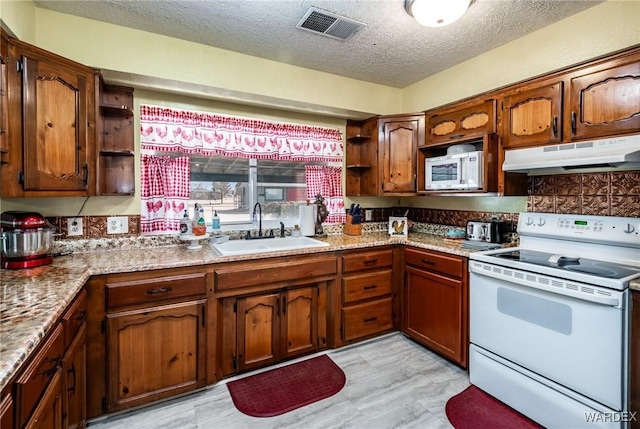 kitchen featuring white appliances, visible vents, open shelves, a sink, and under cabinet range hood