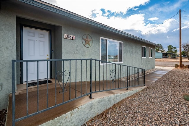 doorway to property with stucco siding