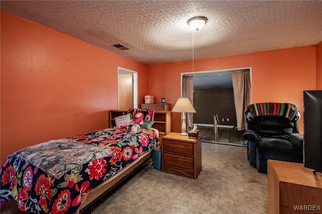 bedroom with visible vents and a textured ceiling