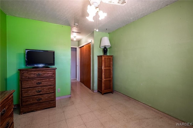 bedroom with tile patterned floors, a closet, and a textured ceiling