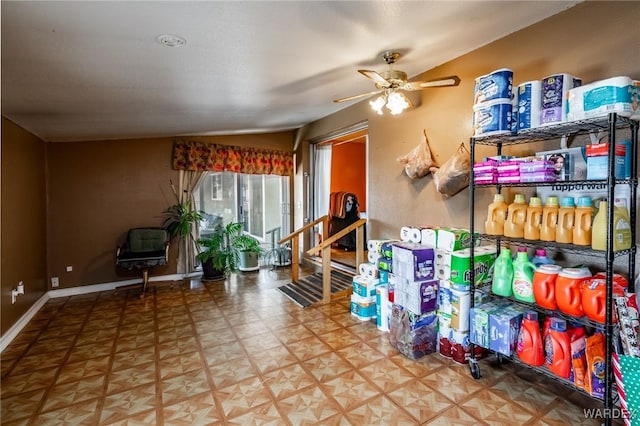 interior space with ceiling fan