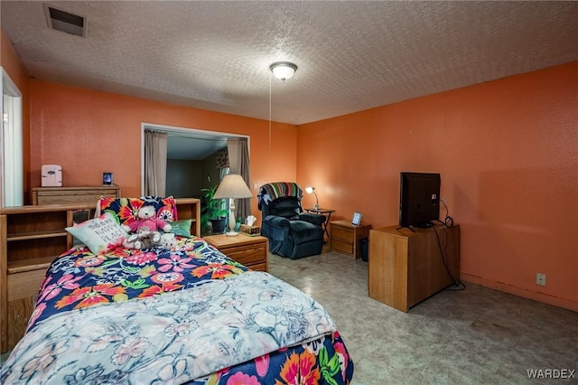 bedroom with carpet flooring, baseboards, visible vents, and a textured ceiling