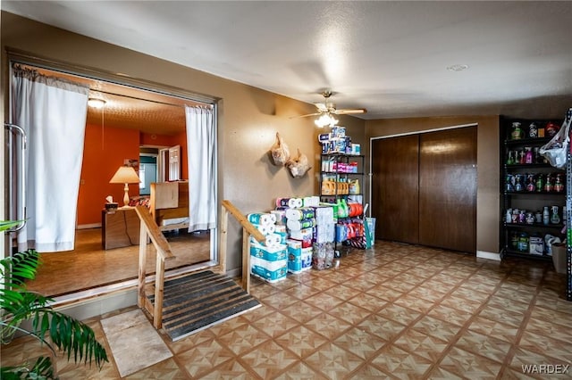 playroom featuring baseboards and ceiling fan