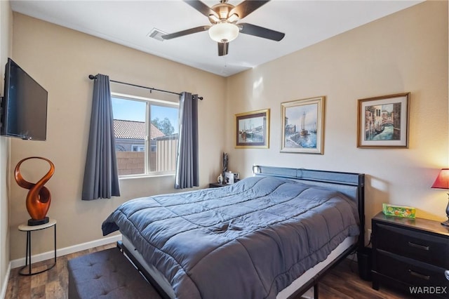 bedroom featuring ceiling fan, baseboards, visible vents, and dark wood finished floors