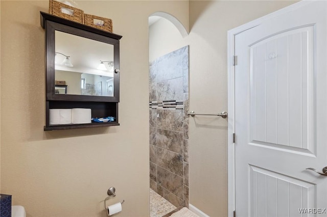 full bathroom with tiled shower