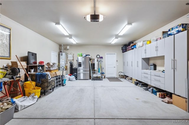 garage with water heater, stainless steel refrigerator with ice dispenser, and a garage door opener