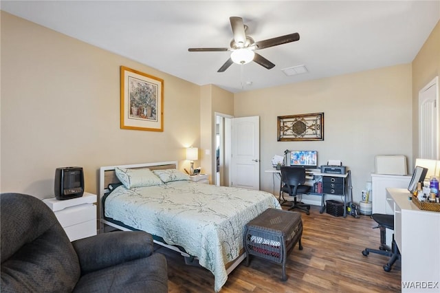 bedroom featuring ceiling fan, visible vents, and wood finished floors