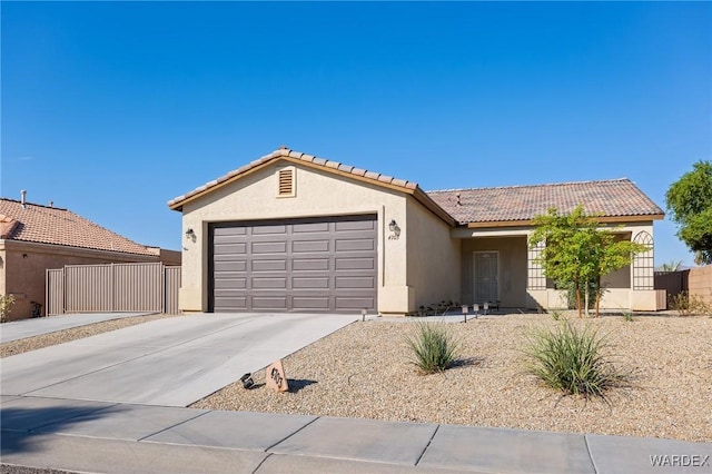 ranch-style home featuring a garage, driveway, a tiled roof, and stucco siding