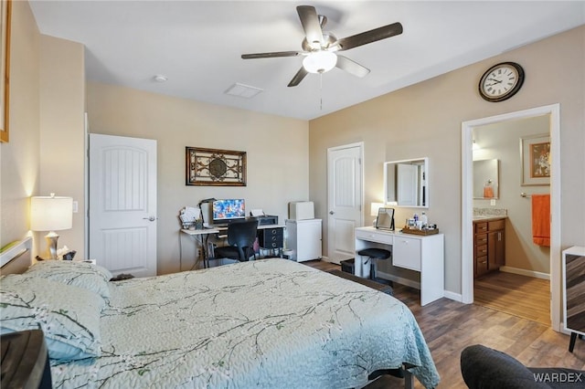 bedroom featuring dark wood finished floors, visible vents, a ceiling fan, connected bathroom, and baseboards