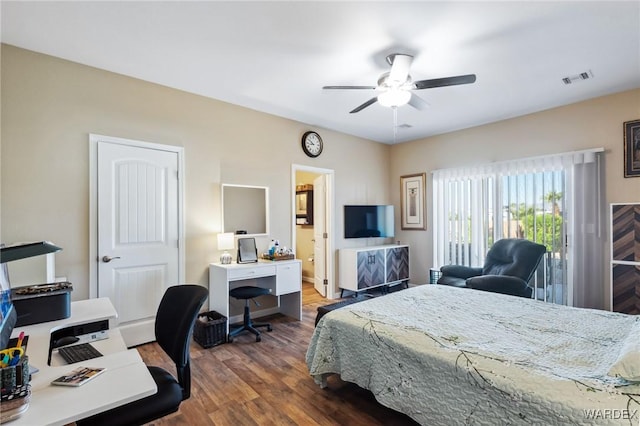 bedroom featuring dark wood finished floors, visible vents, a ceiling fan, connected bathroom, and baseboards