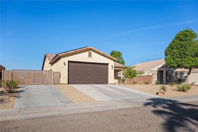 ranch-style home featuring an attached garage, a tile roof, concrete driveway, and stucco siding