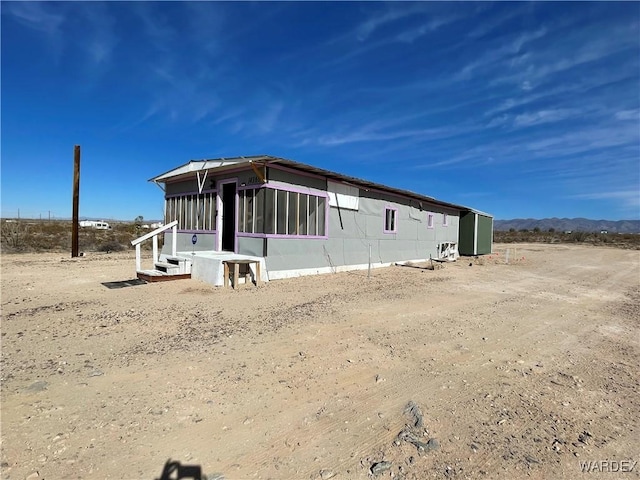 view of side of home with a sunroom