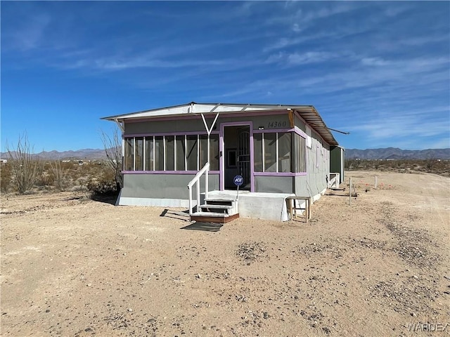 manufactured / mobile home with a sunroom and a mountain view