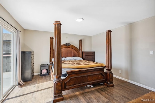 bedroom with baseboards and wood finished floors