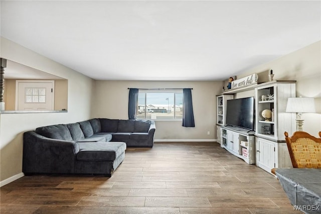 living room featuring baseboards and wood finished floors