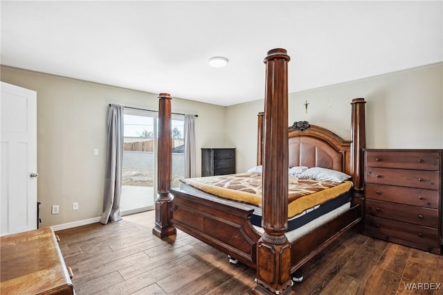 bedroom featuring access to outside, baseboards, and dark wood-type flooring