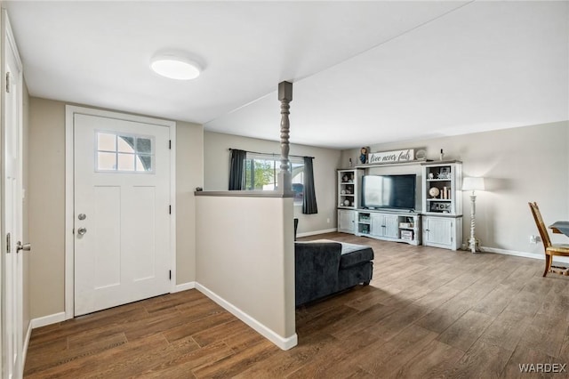 foyer entrance with baseboards and wood finished floors