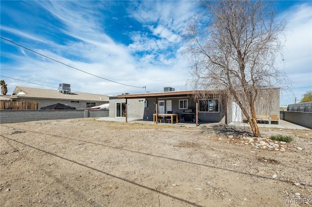 view of front of property featuring a patio area and a fenced backyard