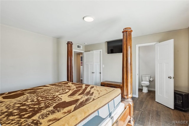 bedroom featuring a closet, baseboards, and dark wood-style flooring