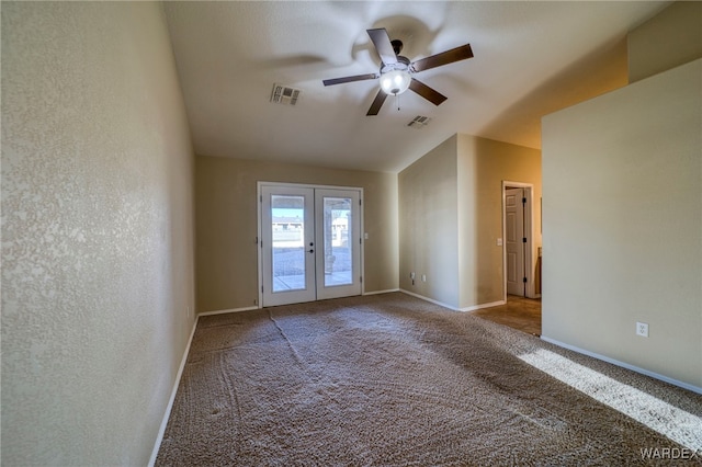 spare room with carpet, french doors, visible vents, and baseboards