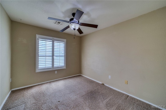 carpeted empty room with a ceiling fan, visible vents, and baseboards