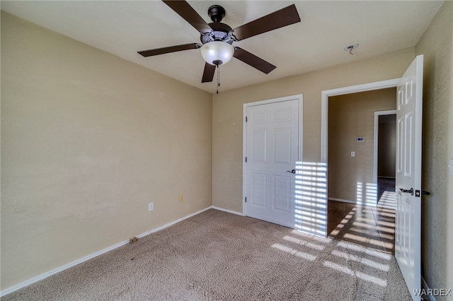 unfurnished bedroom with carpet floors, ceiling fan, and baseboards