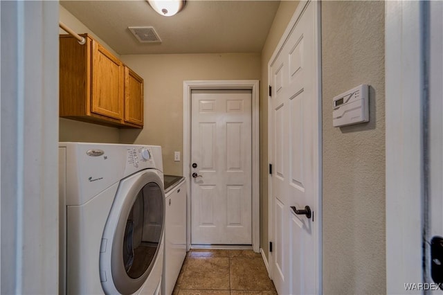 laundry area featuring cabinet space, visible vents, and separate washer and dryer