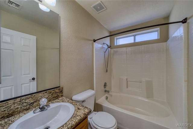 full bathroom with visible vents, a textured wall, bathing tub / shower combination, and toilet