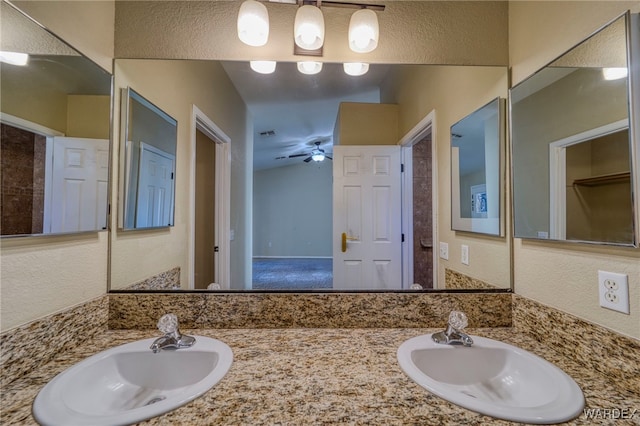 full bath with a textured wall and a sink