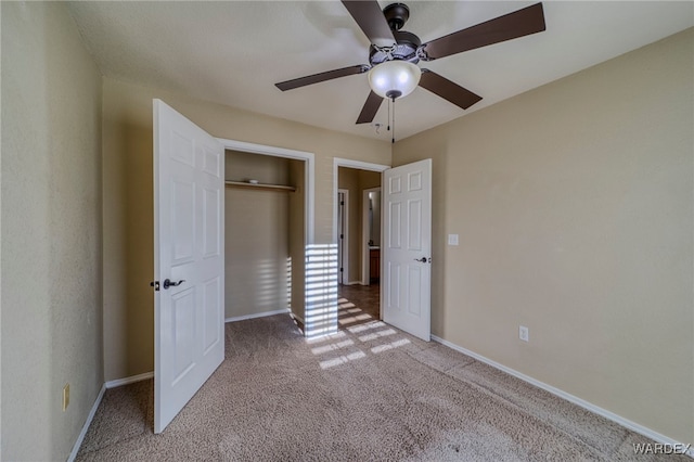 unfurnished bedroom featuring light carpet, ceiling fan, baseboards, and a closet